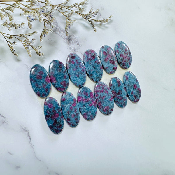 Large Deep Blue Oval Ruby in Kyanite, Set of 12 Background